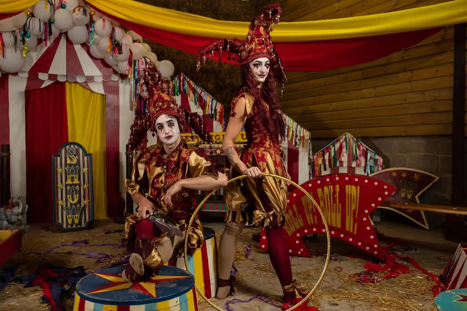 Circus performers in a big top themed set